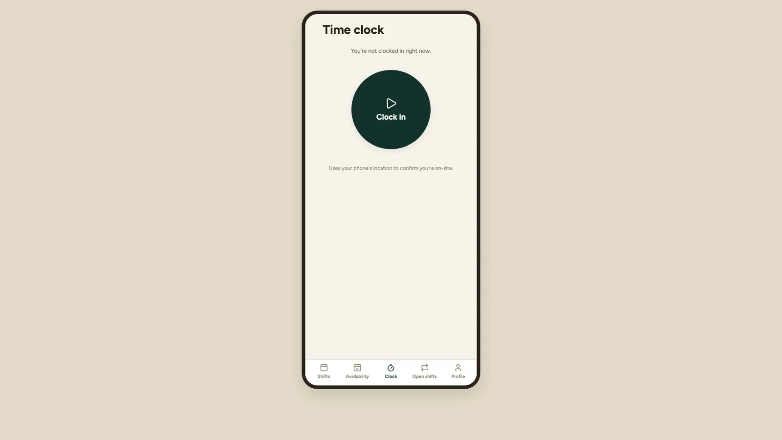 The time clock screen on a phone: “You’re not clocked in right now” above a large circular Clock in button, with a note that it uses the phone’s location to confirm the person is on site.